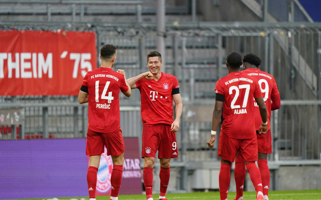 Robert Lewandowski celebrates with Bayern Munich teammates.