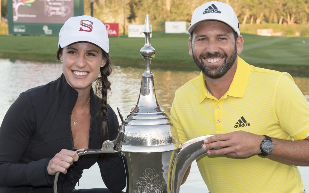 Sergio Garcia and fiancé Angela Akins poses with the Dubai trophee.