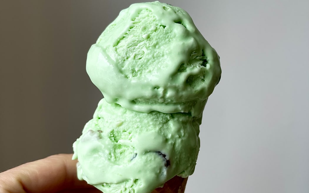 Homemade Goody Gumdrop Ice Cream - a close up of a hand holding a cone topped with two scoops