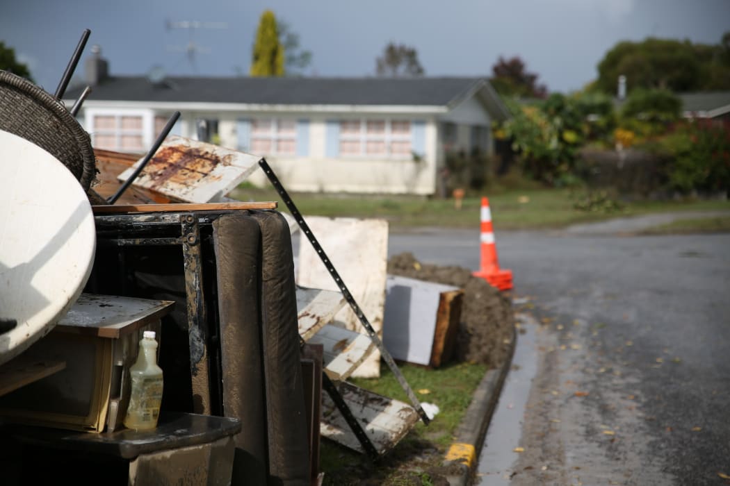 Household items are being piled on the curbside.