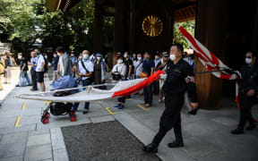 Members of a far right group parade inside the Yasukuni shrine in Tokyo on August 15.