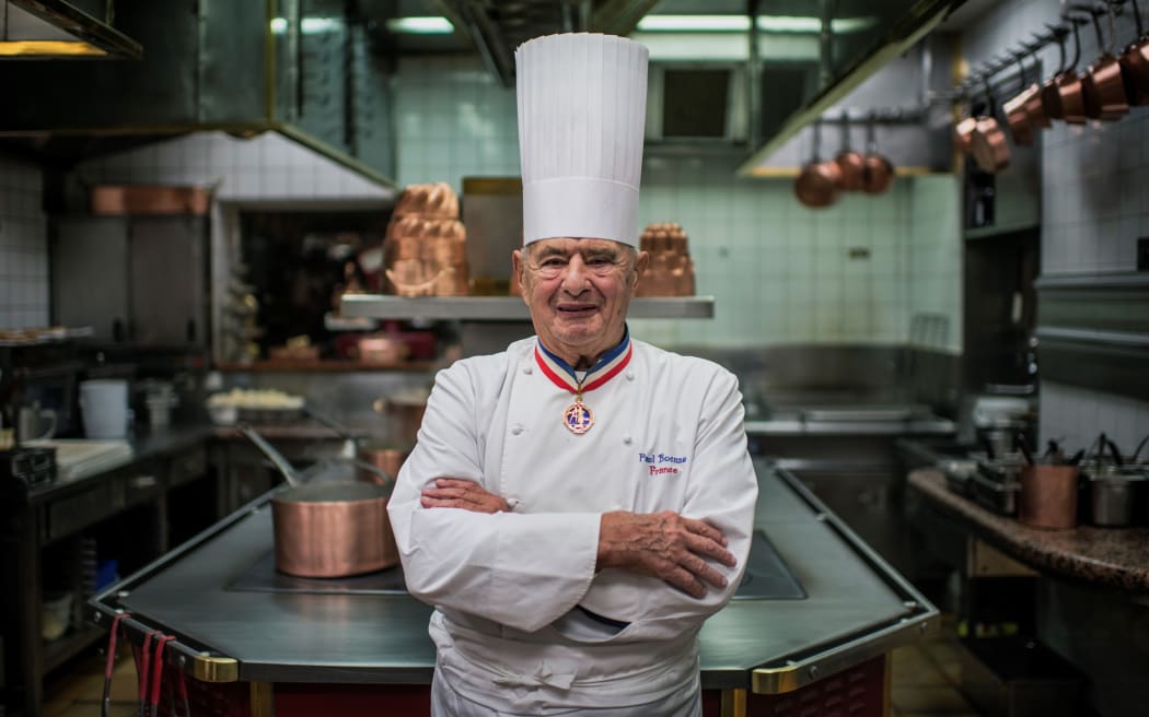 This file photo taken in 2012 shows French chef Paul Bocuse posing in his kitchen at L'Auberge de Pont de Collonges, during a culinary work shop.
