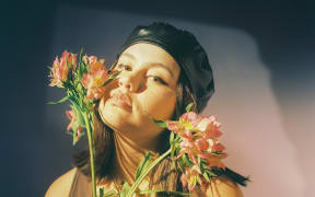 Paige, sniffing flowers