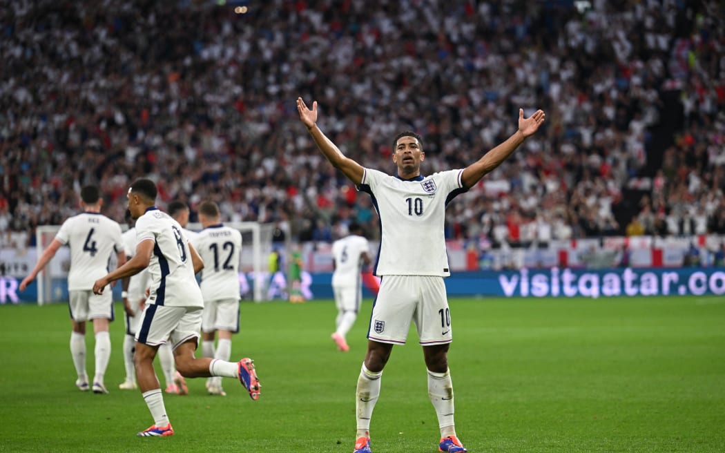 England's midfielder Jude Bellingham celebrates scoring his team's first goal during the UEFA Euro 2024 Group C football match between Serbia and England.