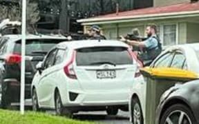 Police surround a property in the west Auckland suburb of New Lynn 17 July 2024