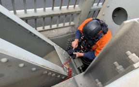 Taking photos of damage underneath the bridge.