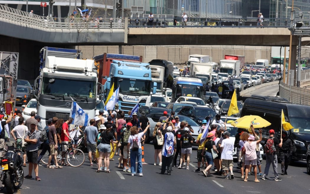 Demonstrators block a Tel Aviv road during an anti-government protest demanding a deal to release Israelis detained by Hamas in the Gaza Strip.