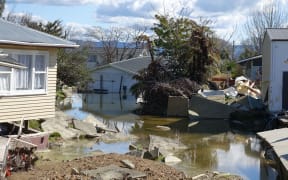 Houses on College Road that were devastated by the flood lie broken and abandoned.