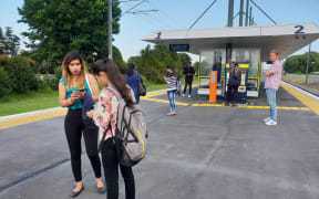 Stranded passengers await for updates on the train situation at Takanini train station.