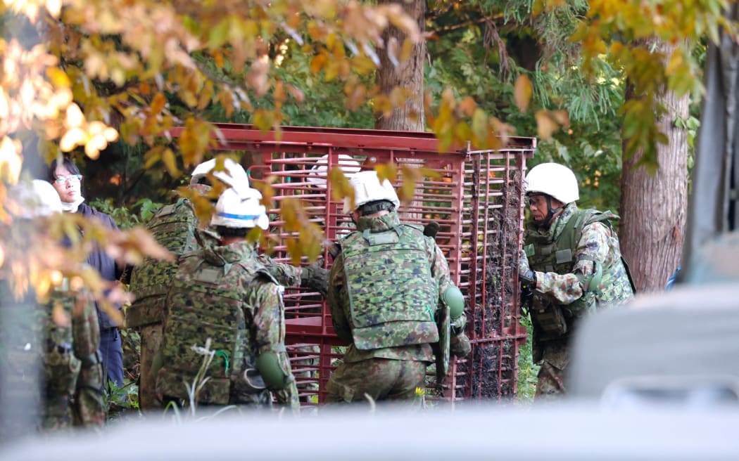 Members of the Japan Self-Defense Forces set up bear traps and are on guard against bears in Kazuno City, Akita Prefecture, Japan, on November 5, 2025. There have been a series of human casualties caused by bears in Akita Prefecture and other parts of Japan.( The Yomiuri Shimbun ) (Photo by Hidenori Nagai / The Yomiuri Shimbun via AFP)