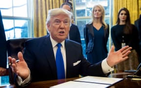 President Donald Trump before signing an executive order reviving the construction of two controversial oil pipelines.