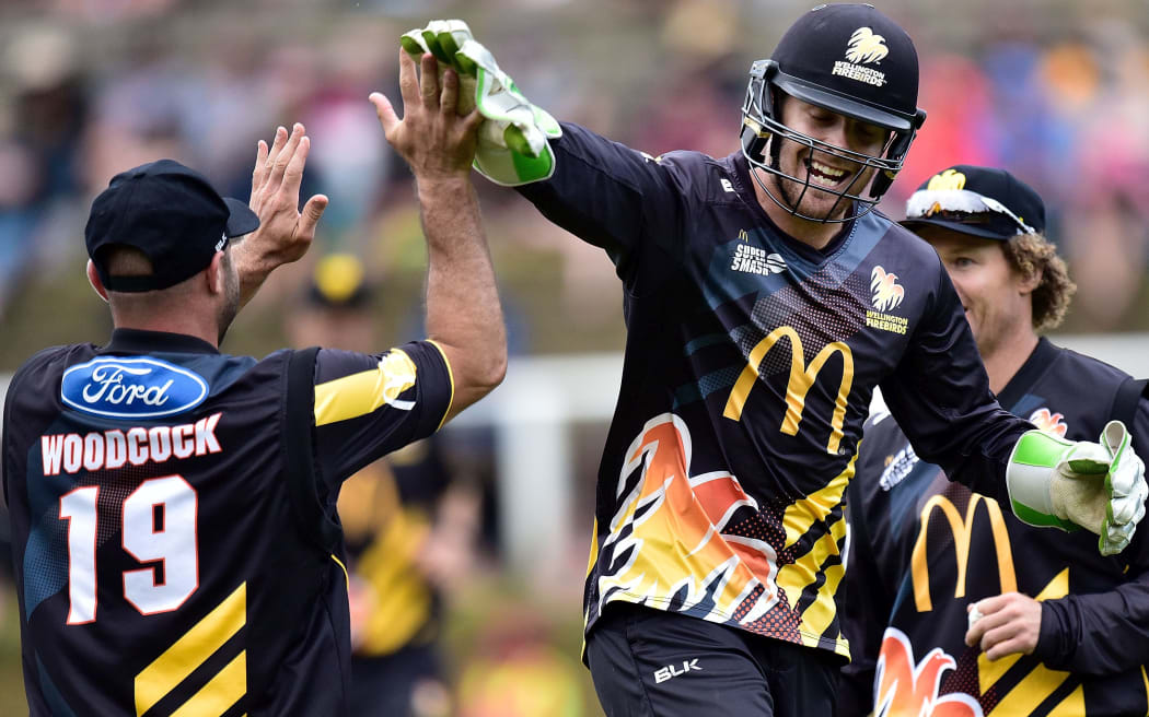 Firebirds' Luke Woodcock (L) celebrates with team mate Tom Blundell and captain Hamish Marshall.