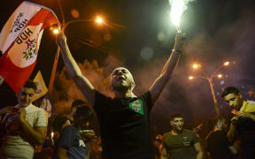 A man waves a flag of the pro-Kurdish Peoples' Democratic Party after the results of the Turkish presidential and parliamentary elections.