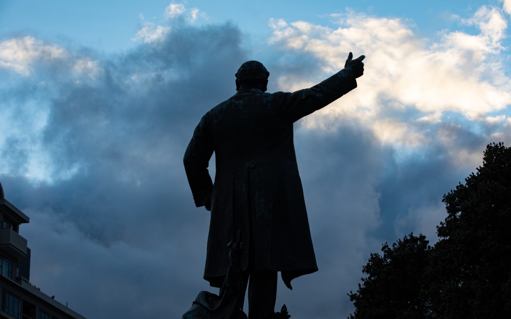 Parliament's statue of Richard Seddon silhouetted against the dawn
