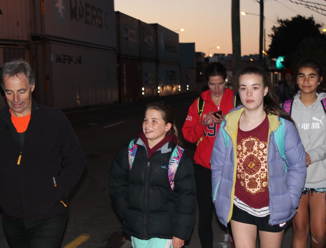 A photo of the CEO of World Vision, Chris Clarke, walks the last leg of the trip with pupils as night falls