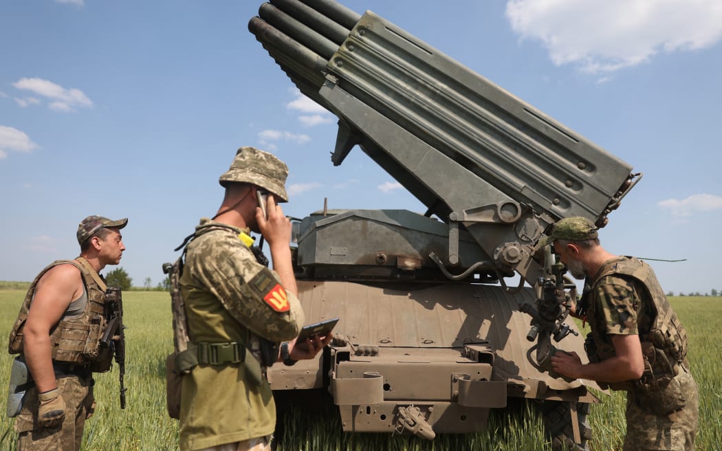 Ukrainian artillerymen prepare to fire a BM-21 Grad multiple rocket launcher near Izyum, south of Kharkiv, on 11 June, 2022 amid the Russian invasion of Ukraine.