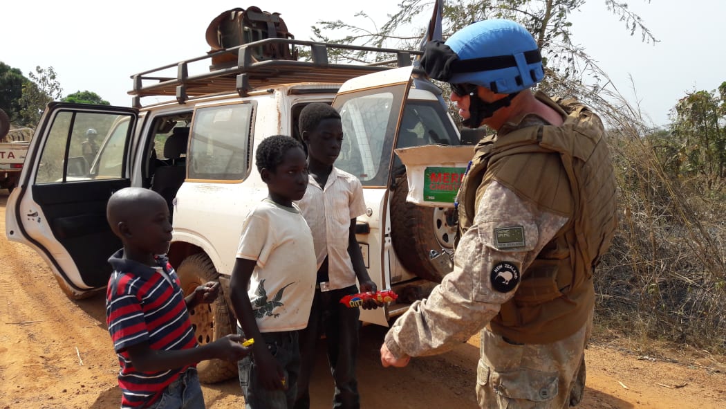 One of the New Zealanders on patrol with the UN Mission in South Sudan, talking and sharing treats with children near Juba.