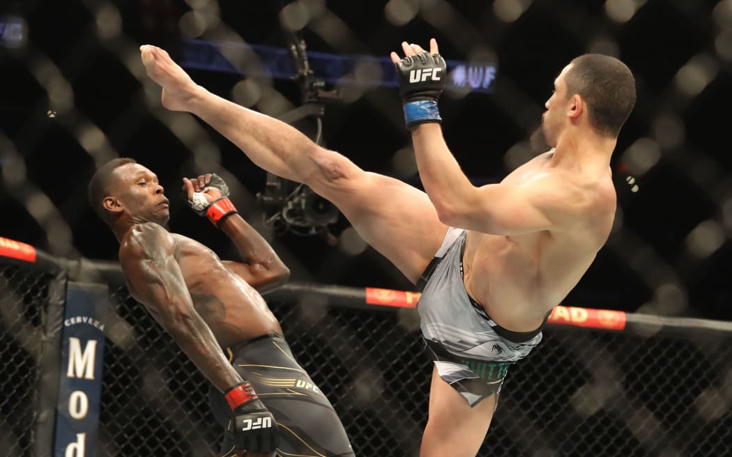 Israel Adesanya avoids a kick from Robert Whittaker, Houston 2022 at UFC 271.