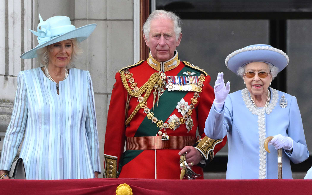 Britain's Queen Elizabeth II (R) stands with Britain's Camilla, Duchess of Cornwall (L) and Britain's Prince Charles, Prince of Wales to watch a special flypast from Buckingham Palace balcony following the Queen's Birthday Parade, the Trooping the Colour, as part of Queen Elizabeth II's platinum jubilee celebrations, in London on June 2, 2022. - Huge crowds converged on central London in bright sunshine on Thursday for the start of four days of public events to mark Queen Elizabeth II's historic Platinum Jubilee, in what could be the last major public event of her long reign. (Photo by Daniel LEAL / AFP)