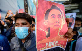 A protester holds a photo of detained Myanmar civilian leader Aung San Suu Kyi during a demonstration against the military coup.