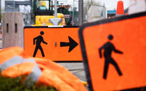 Signs alongside roadworks tell pedestrians where to go