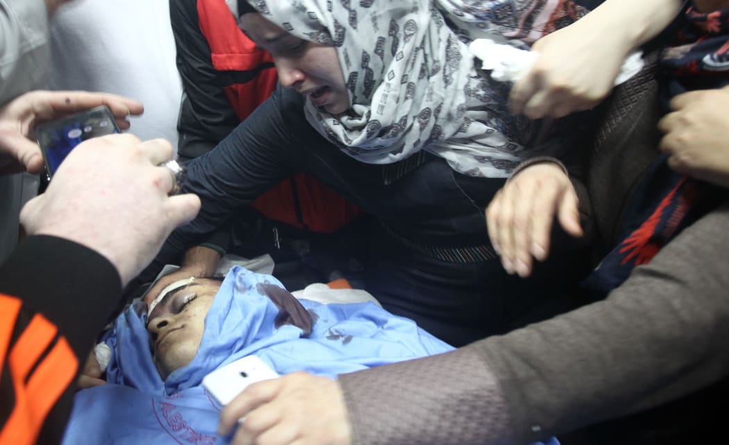 Relatives mourn over the body of Palestinian Mohammed Fares al-Jaabari who died near the Israeli settlement of Kiriat Arba.