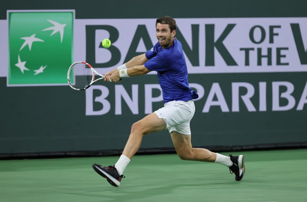 Cameron Norrie of Great Britain plays a backhand against Nikoloz Basilashvili of Georgia in the men's final match on Day 14 of the BNP Paribas Open at the Indian Wells Tennis Garden on October 17, 2021 in Indian Wells, California.