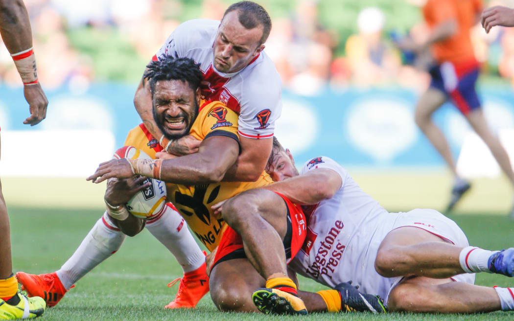Garry Lo cops a high shot during Papua New Guinea's World Cup quarter final showdown against England.