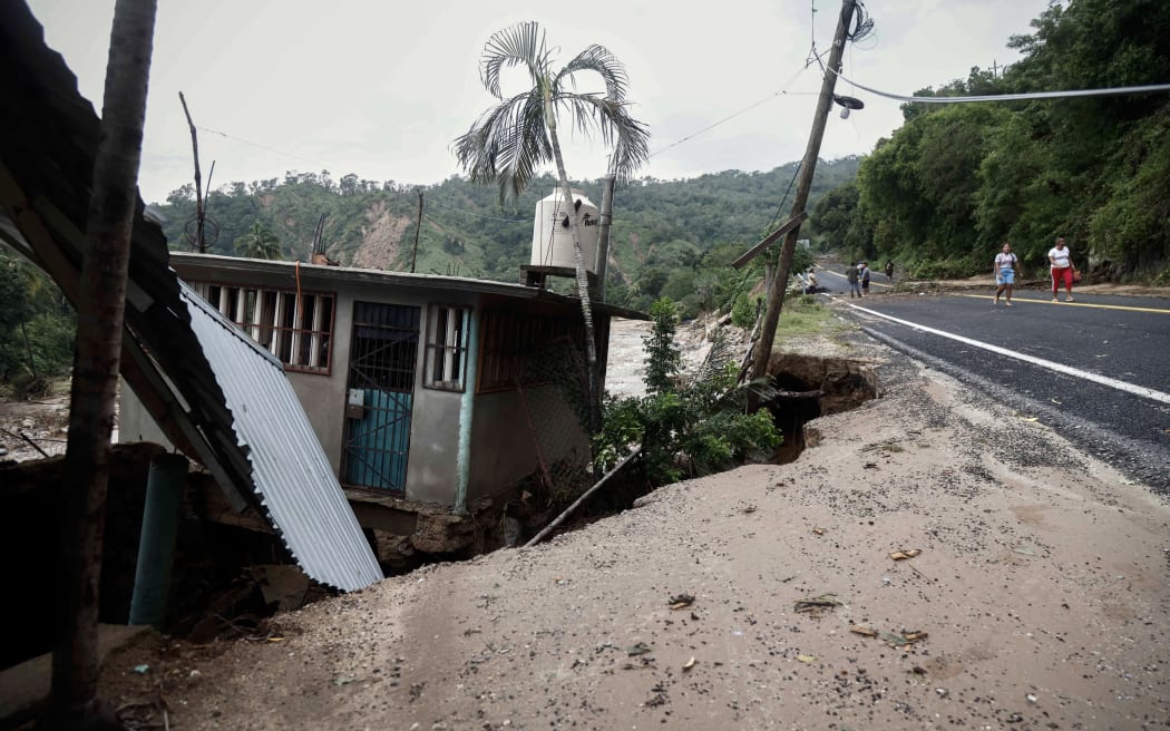 A picture of a house on land which gave way at the Kilometro 42 community, near Acapulco, Guerrero State, Mexico, after the passage of Hurricane Otis, on 25 October, 2023.