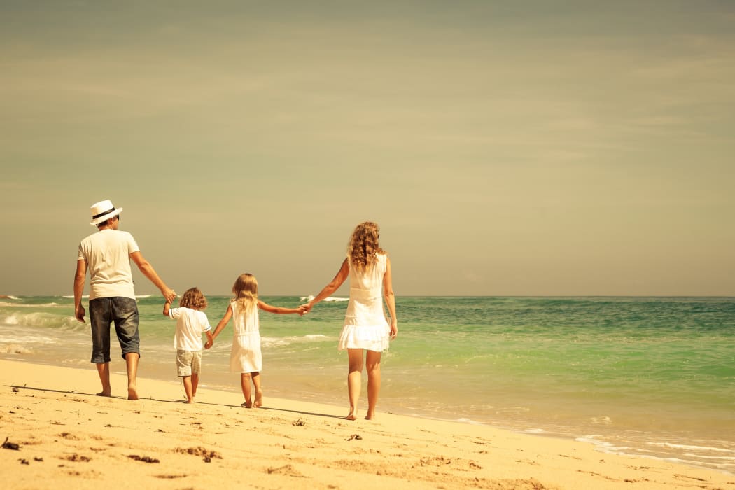 Family walking at the beach.