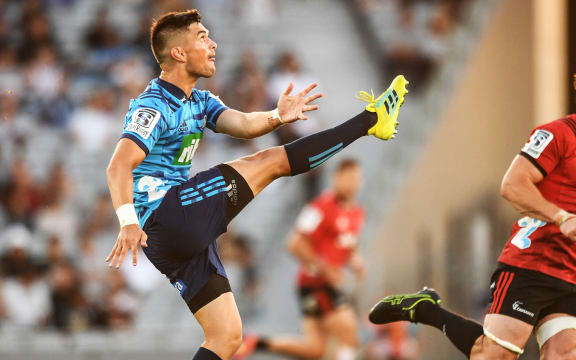 Blues first-five Otere Black unleashes a kick.