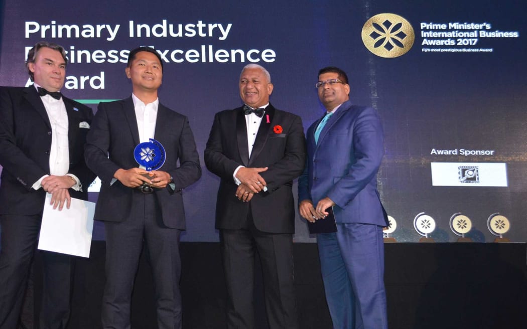 Fiji's prime minister Frank Bainimarama, second from right, is pictured at the awarding of a Prime Minister's Business Award to a member of Grace Road Group, the church's business arm, in 2017.
