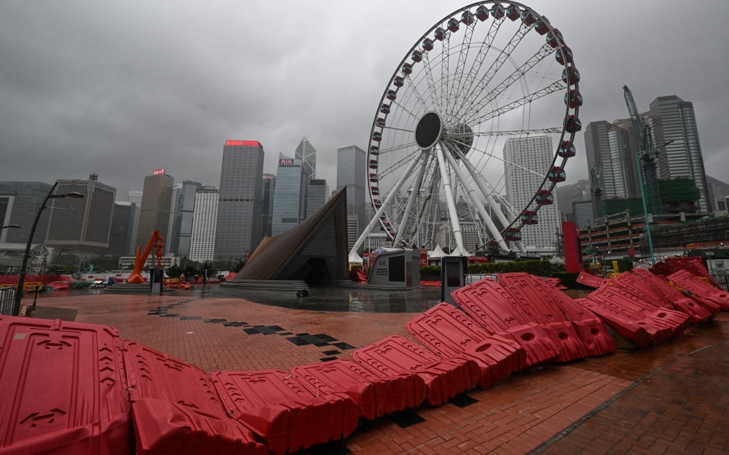 Barricades are blown down in the Central district as the typhoon signal number 10 is hoisted as Typhoon Wipha moves towards Hong Kong on July 20, 2025. (Photo by Peter PARKS / AFP)