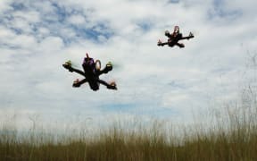 Drone racing over the green field