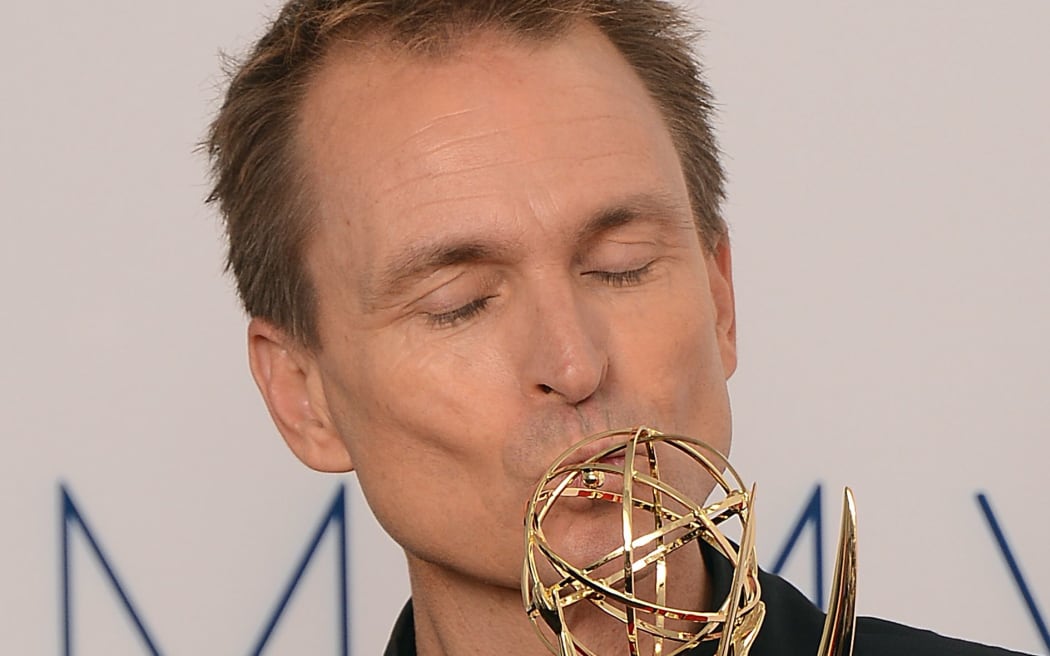 Phil Keoghan celebrates winning an Emmy for the Amazing Race in 2012.