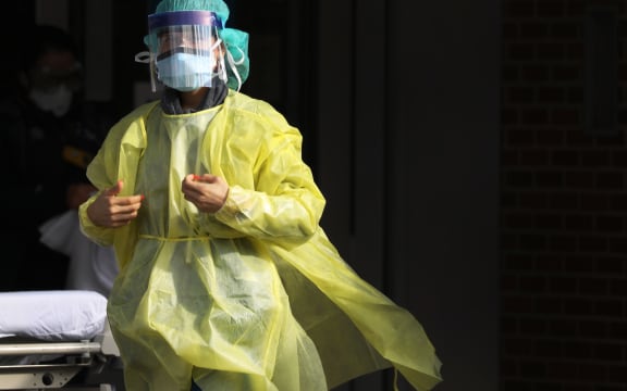 A medical worker walks outside of a special coronavirus intake area at Maimonides Medical Center on April 10, 2020 in New York City.