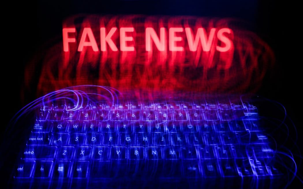 'Fake news' sign is seen displayed on a laptop screen in this long exposure illustration photo taken on June 13, 2020. (Photo by Jakub Porzycki/NurPhoto) (Photo by Jakub Porzycki / NurPhoto / NurPhoto via AFP)