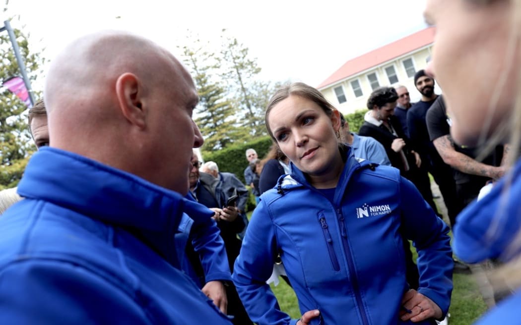 Katie Nimon - seen here at a National Party rally with Luxon on 11 October - is hoping to beat Labour's Mark Hutchinson in the Napier electorate.