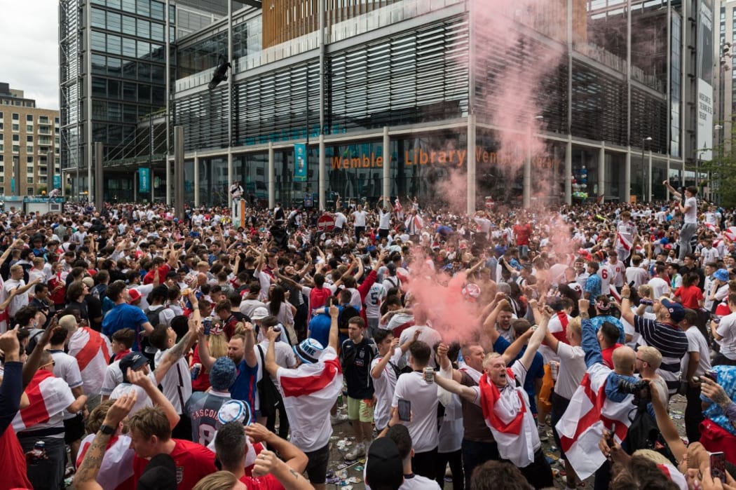 LONDON, UNITED KINGDOM - JULY 11, 2021: England football fans celebrate outside Wembley Stadium ahead of England match against Italy in the final of Euro 2020 Championship on July 11, 2021 in London, England.