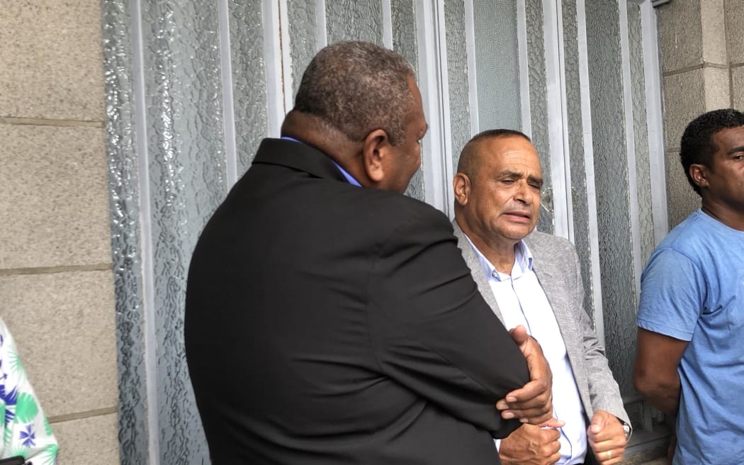 Qiliho waits outside the Magistrates Court.