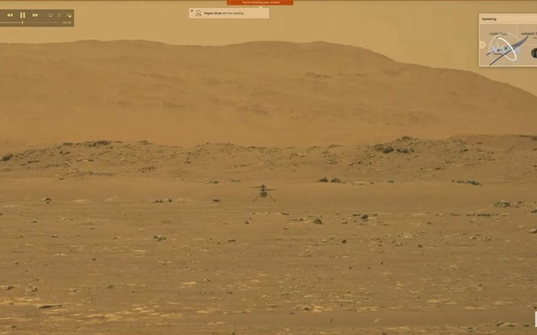 This video grab made from a NASA live stream on April 19, 2021 shows the agency's Ingenuity Mars Helicopter flying over the surface of Mars. - NASA successfully flew the Ingenuity helicopter on Mars on April 19, data downloaded from the aircraft confirmed.