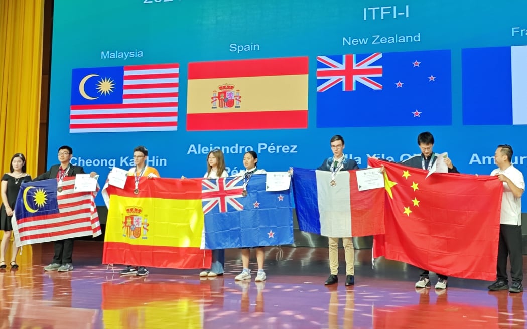 The New Zealand team at the 17th International Earth Science Olympiad in Beijing. Ella Yile Qiu on stage.