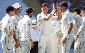 Trent Boult celebrates with team mates after taking the wicket of Stokes.