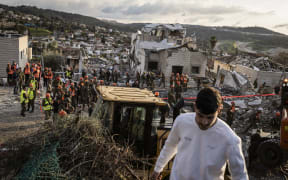 Israeli emergency service officers search through the debris at the scene of a missile attack in Bet Shemesh, some 30 kilometres west of Jerusalem on March 1, 2026. A barrage of missiles launched from Iran killed at least six people in the central Israel city of Bet Shemesh on March 1, Israel's first responders agency, Magen David Adom (MDA) said, the day after the US and Israel attacked Iran and assassinated its supreme leader. (Photo by JOHN WESSELS / AFP)