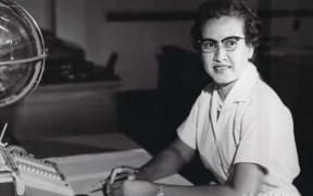 NASA file handout photo shows NASA research mathematician Katherine Johnson at her desk at Langley Research Center.