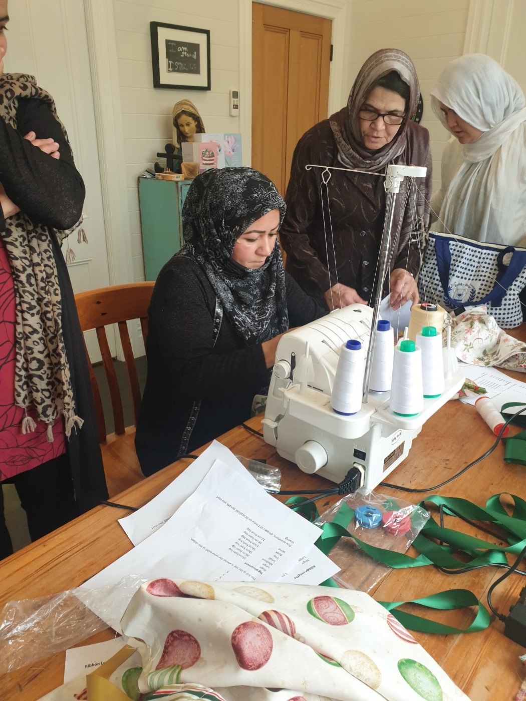 Auckland Afghani women sew reusable gift bags and reusable Christmas crackers. from left. Sara, Fatima, and Suraya attend a training session on June 20