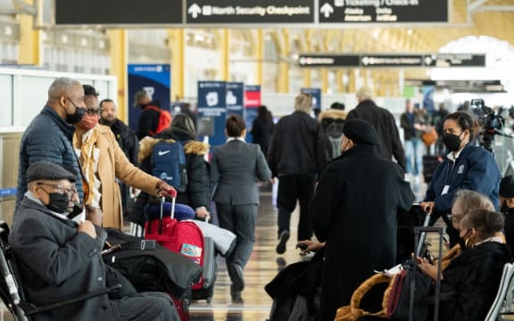 Travelers wait in the terminal for their flights as cancelled and delayed flights mount due to an FAA outage that grounded flights across the US at Ronald Reagan Washington National Airport in Arlington, Virginia, January 11, 2023. - The US Federal Aviation Authority  said Wednesday that normal flight operations "are resuming gradually" across the country following an overnight systems outage that grounded departures. (Photo by SAUL LOEB / AFP)