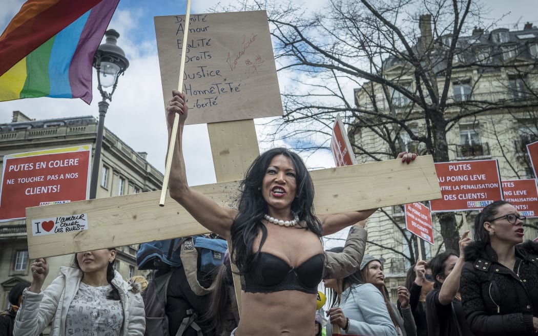 Sex Workers and supporters protest as French lawmakers take part in a final debate on a bill that would make it illegal to pay for sex.