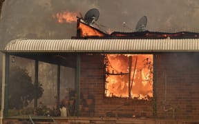 A property burns from bushfires in Balmoral, 150 kilometres southwest of Sydney on December 19, 2019. - A state of emergency was declared in Australia's most populated region on December 19, as a record heat wave fanned unprecedented bushfires. (Photo by PETER PARKS / AFP)