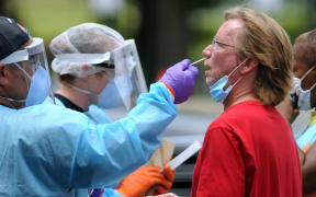 A man who arrived on foot is tested for COVID-19 at a drive-thru testing site at Camping World Stadium on July 22, 2020 in Orlando, Florida.